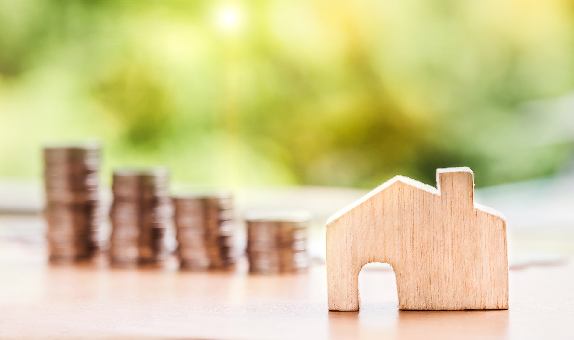 A house miniature and some coins.