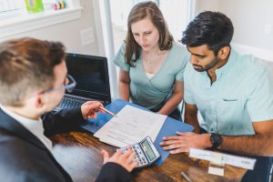 Real estate agent explaining emerging commercial real estate markets to his clients.